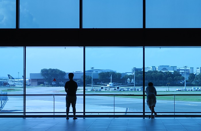 Visitors watch the movement of planes from a viewing gallery at Changi Airport.